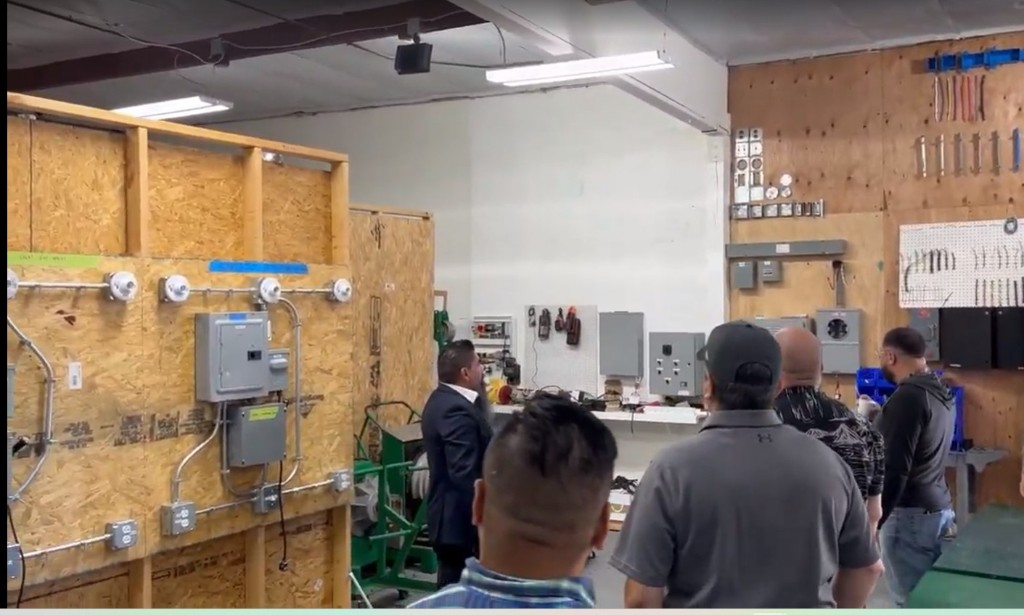 FMWC participants observing hands-on electrical training in a workshop